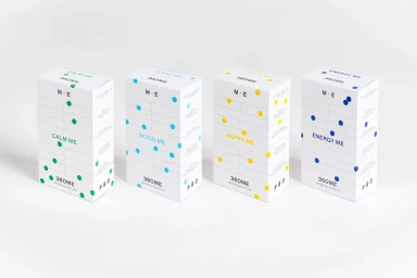 Four white rectangular product packaging boxes with colourful dot patterns arranged in a row against a white background.