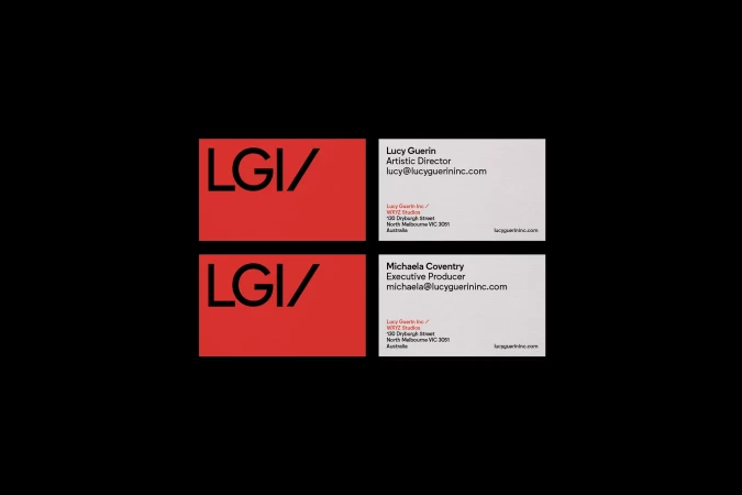 Red and white business cards featuring the 'LGI' logo and contact information for Lucy Guerin and Michaela Coventry.