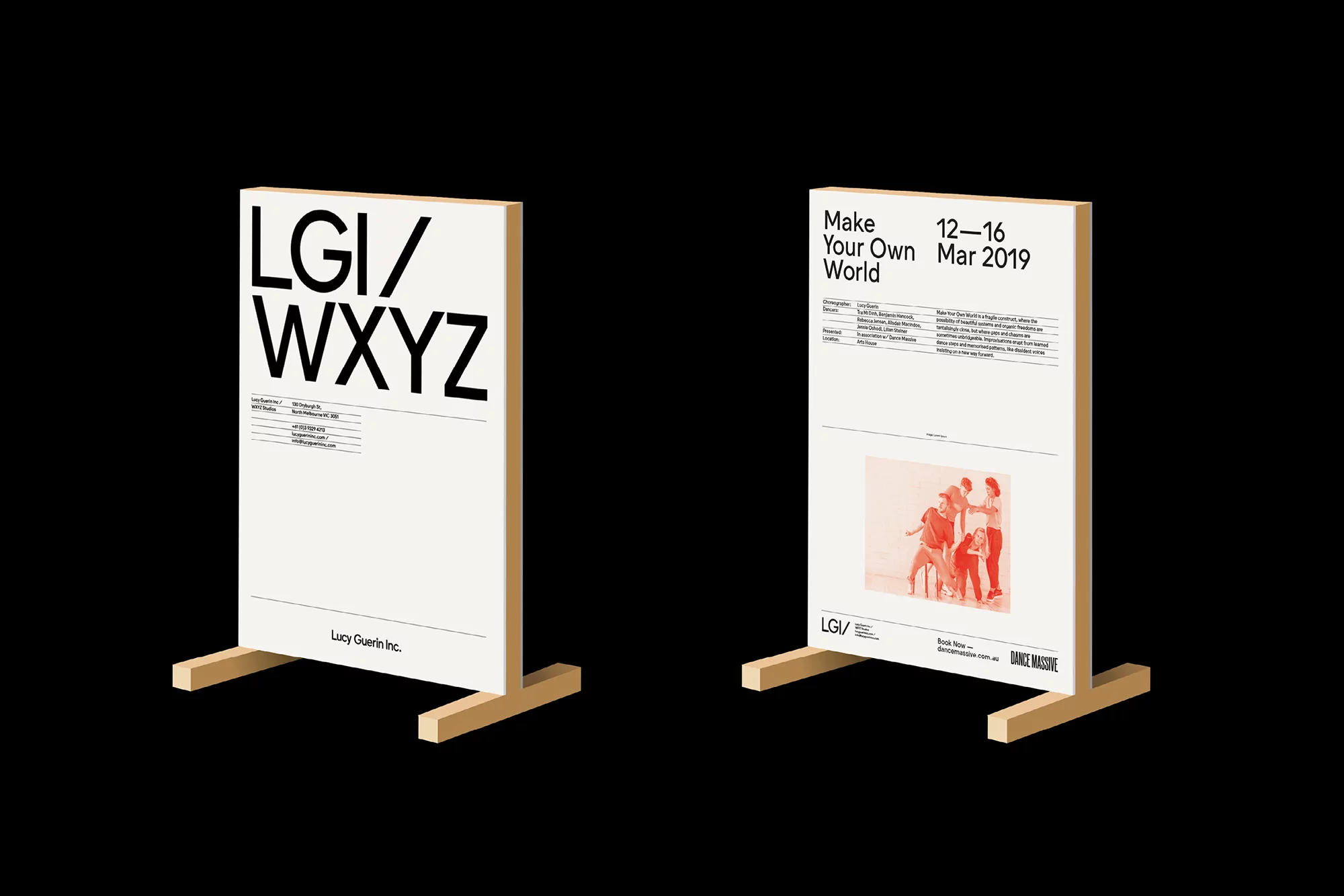 Two poster stands display event posters featuring text and a group dance photo against a dark, isolated background.