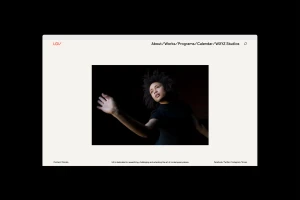 Website mockup displaying a dark framed photograph of a dancer reaching outward against a black background.