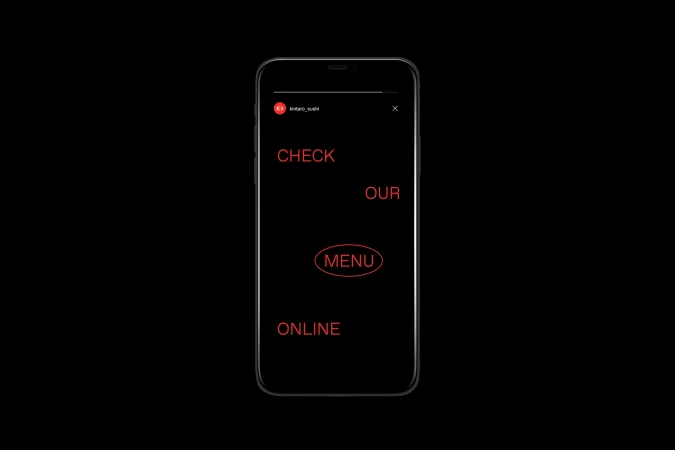 Smartphone displays a digital advertisement: 'Check our Menu Online' in vibrant red against a stark black background.