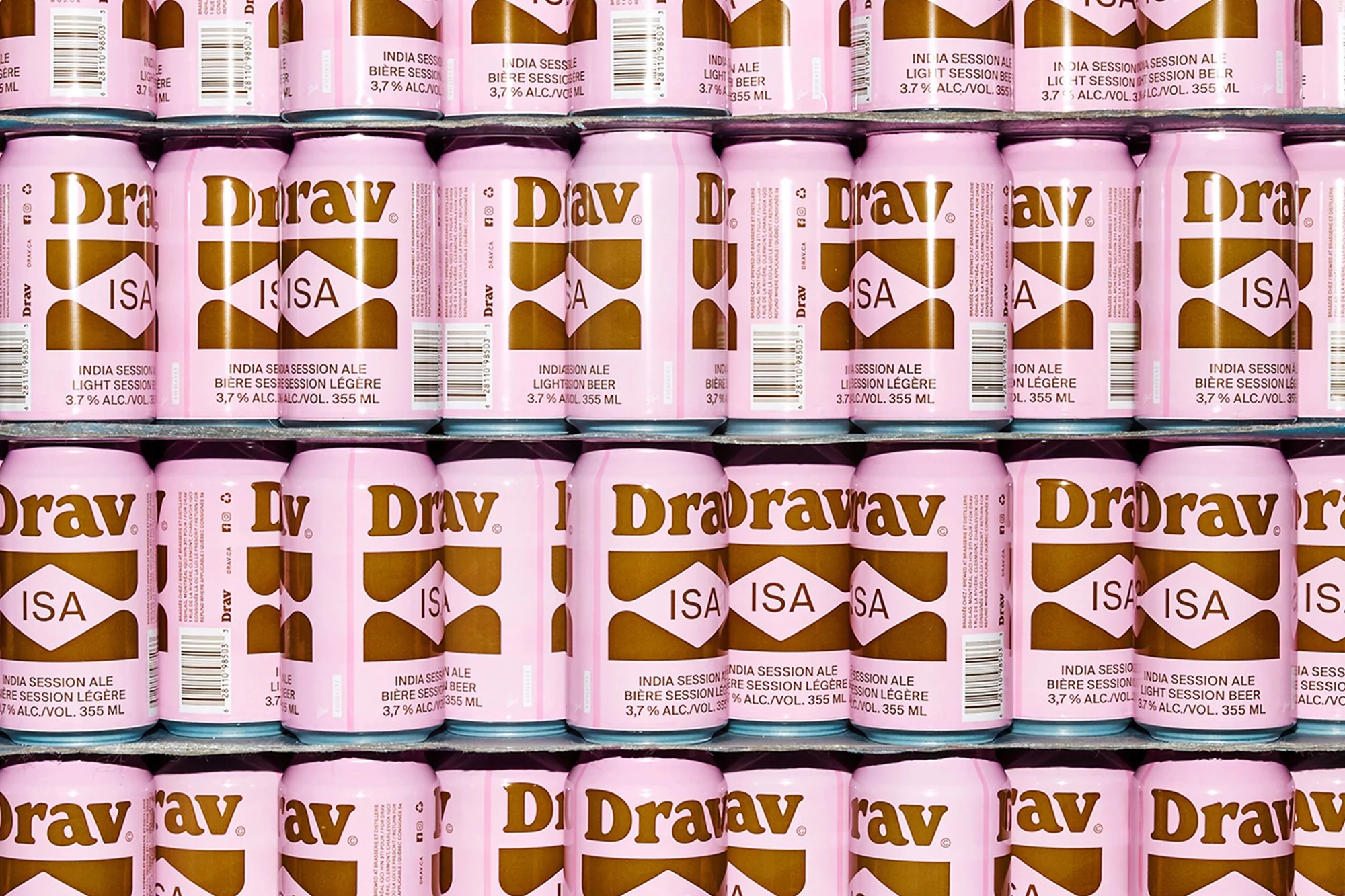 Stacked pink and brown beer cans with "Drav" and "ISA" branding arranged in neat rows.