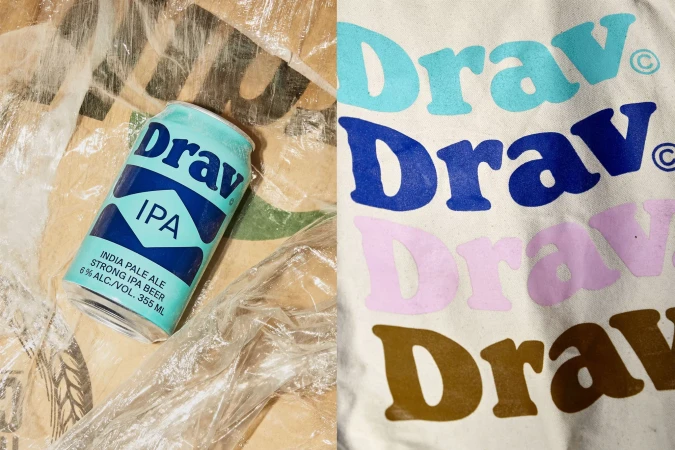 A single can of Drav IPA lies on a textured surface next to a cream-colored tote bag with the word "Drav" printed in four colors.
