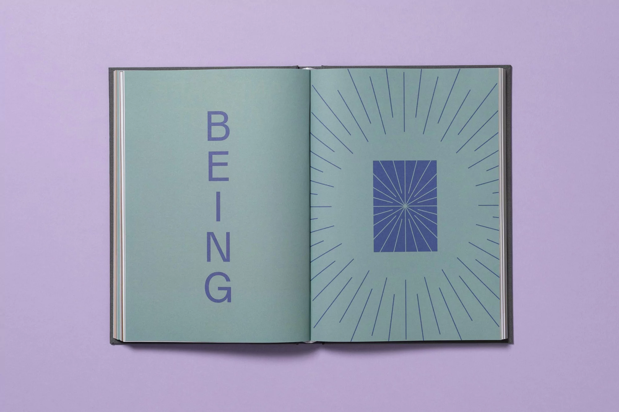 Open book with a mint green page featuring the word 'BEING' in vertical blue letters on the left and a geometric design on the right.