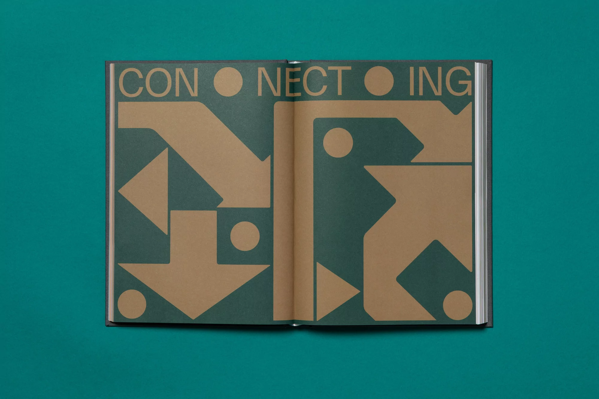 Open book with geometric shapes and the word 'CONNECTING' in green and gold against a teal background, flat lay, eye-level.