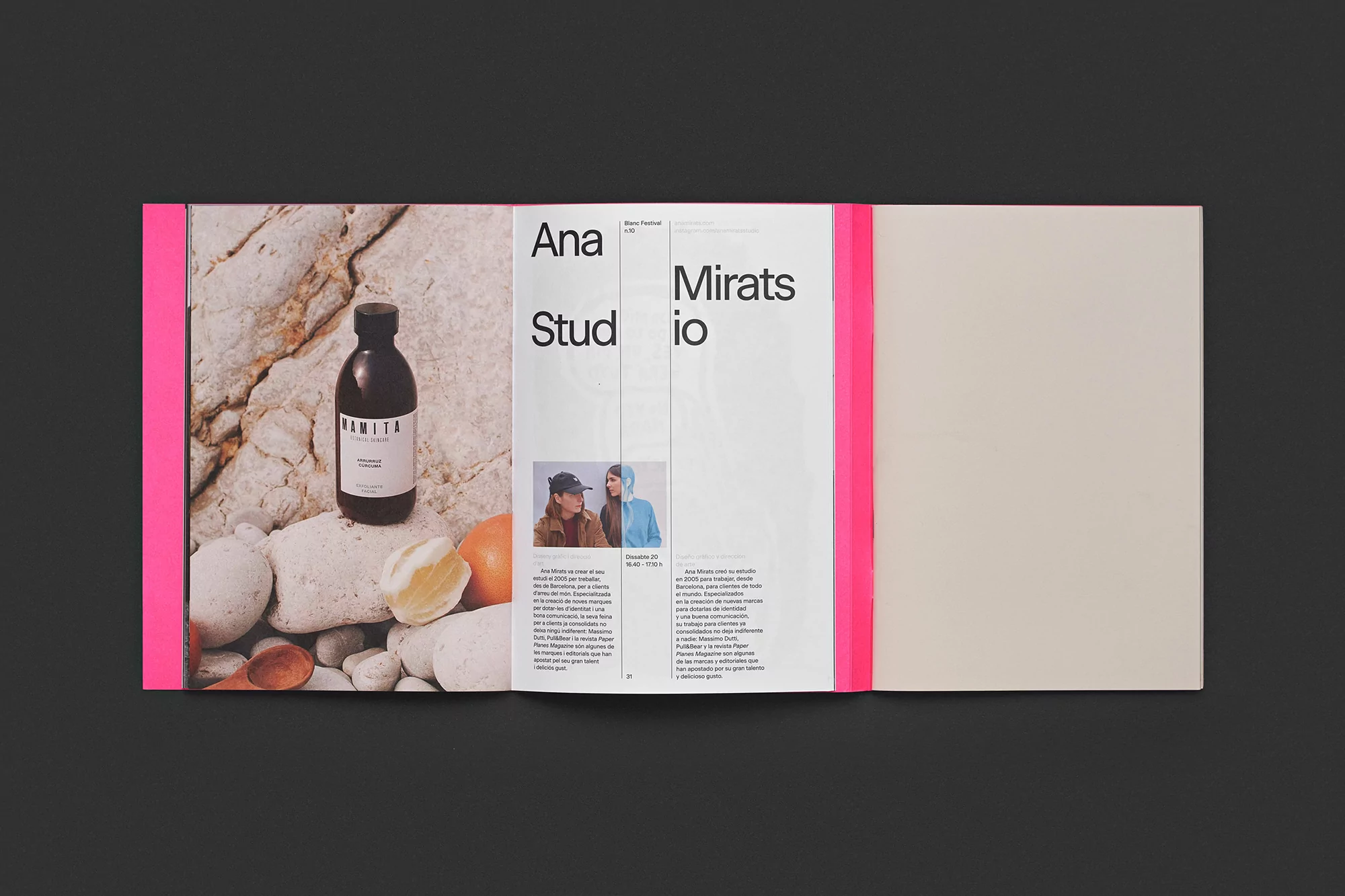 Open magazine spread featuring a product bottle on rocks, studio information, and a blank page with bright pink binding.