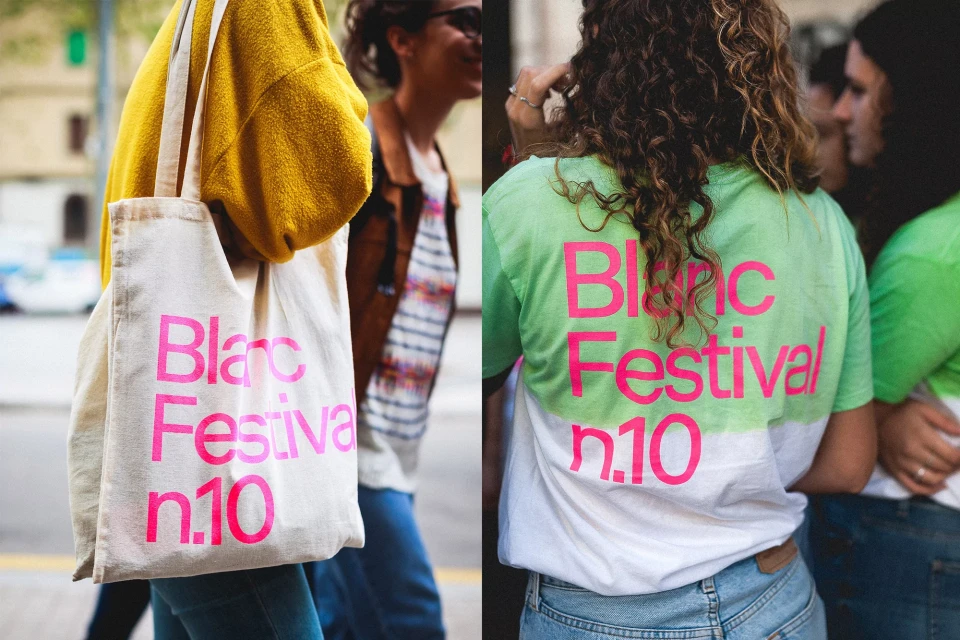 People holding tote bags and wearing t-shirts with the Blanc Festival logo in an outdoor urban environment, showcasing casual fashion.