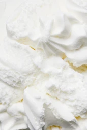 Close-up macro shot of white whipped gelato texture with soft peaks and swirls for Destination Italy
