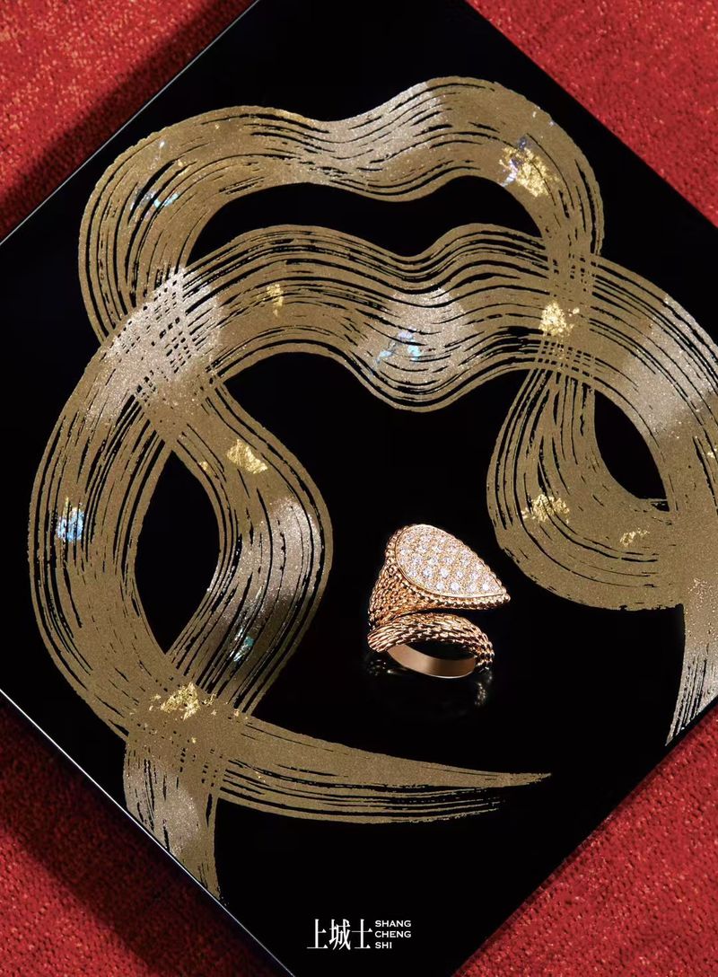 Close-up studio shot of an intricately designed gold ring with gemstones on a glossy black surface with golden brushstroke patterns.
