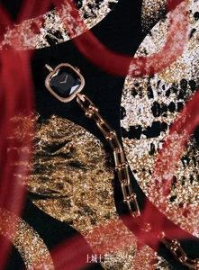 Bulgari luxury watch with a black face and rose gold link bracelet displayed against a textured gold and black patterned background.