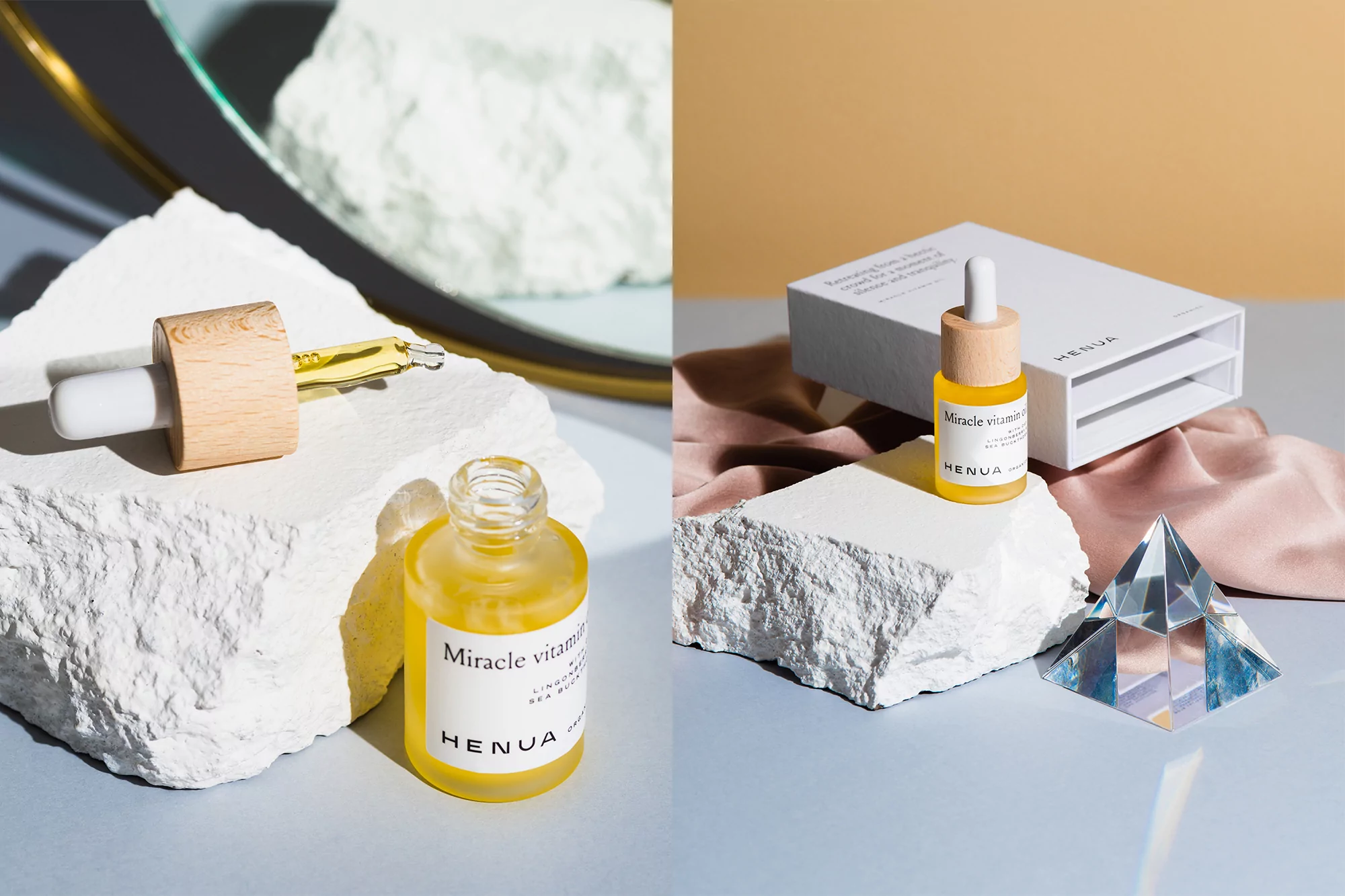 Product shot featuring Henua Miracle Vitamin C skincare serum bottle and dropper on white geometric stone platforms with pyramid decor.