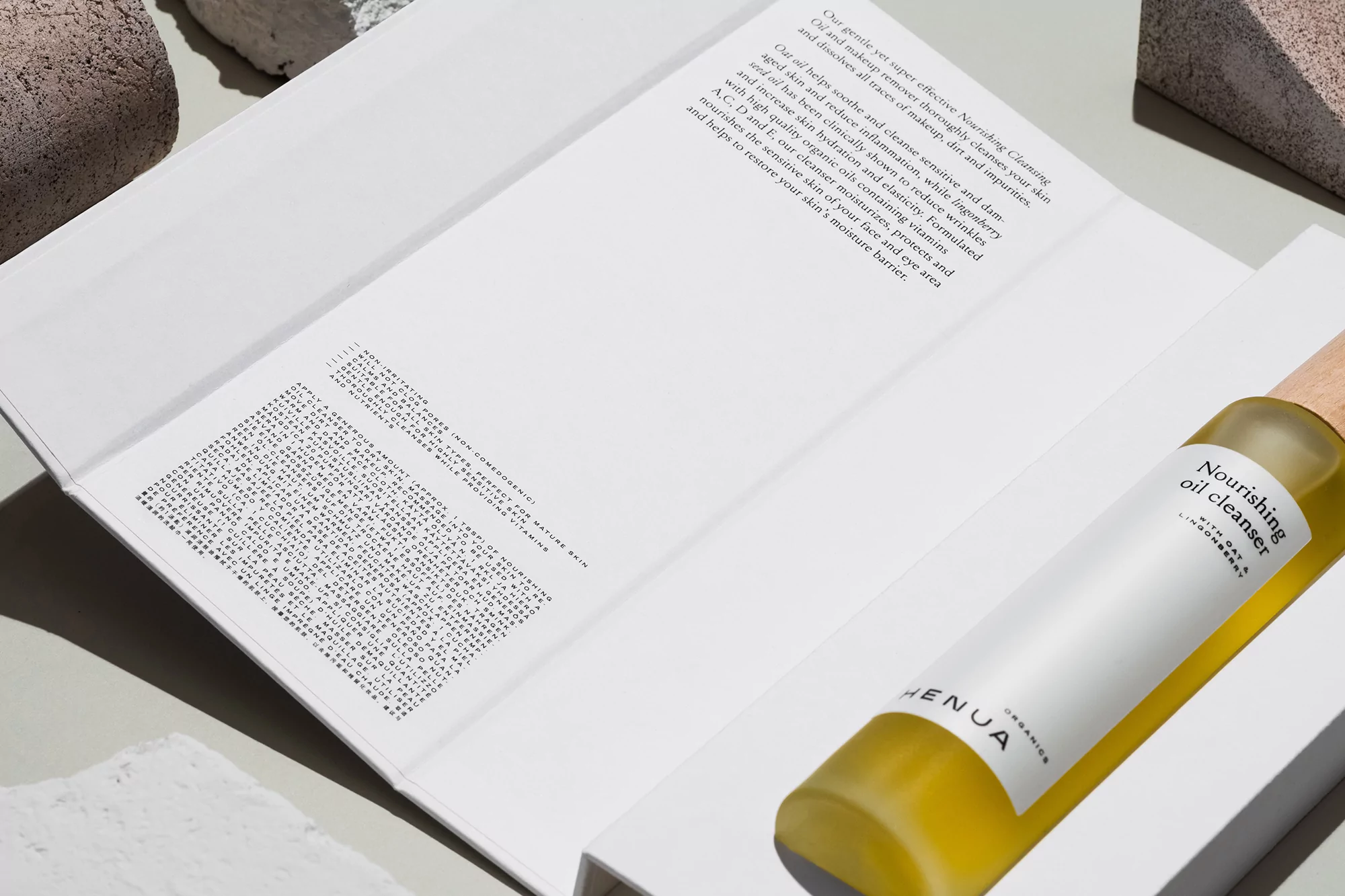 Product shot of Henuia Organics Nourishing Oil Cleanser, showing the bottle and product information, displayed on a white surface.