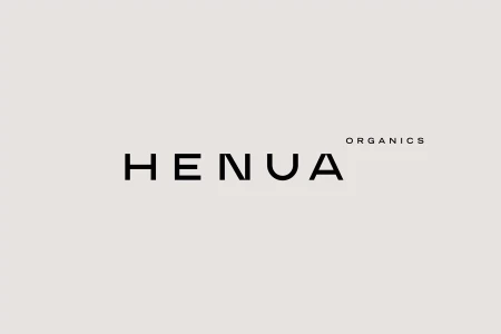 Minimalist black typography spelling Henua Organics centered against a solid warm beige background.