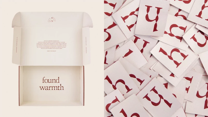 Open cream-colored box with 'found warmth' text, and a pile of white cards with red letter graphics against a neutral background.
