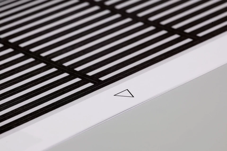 Black and white abstract image of parallel lines intersected by perpendicular lines, creating a grid-like pattern, with a white triangle.