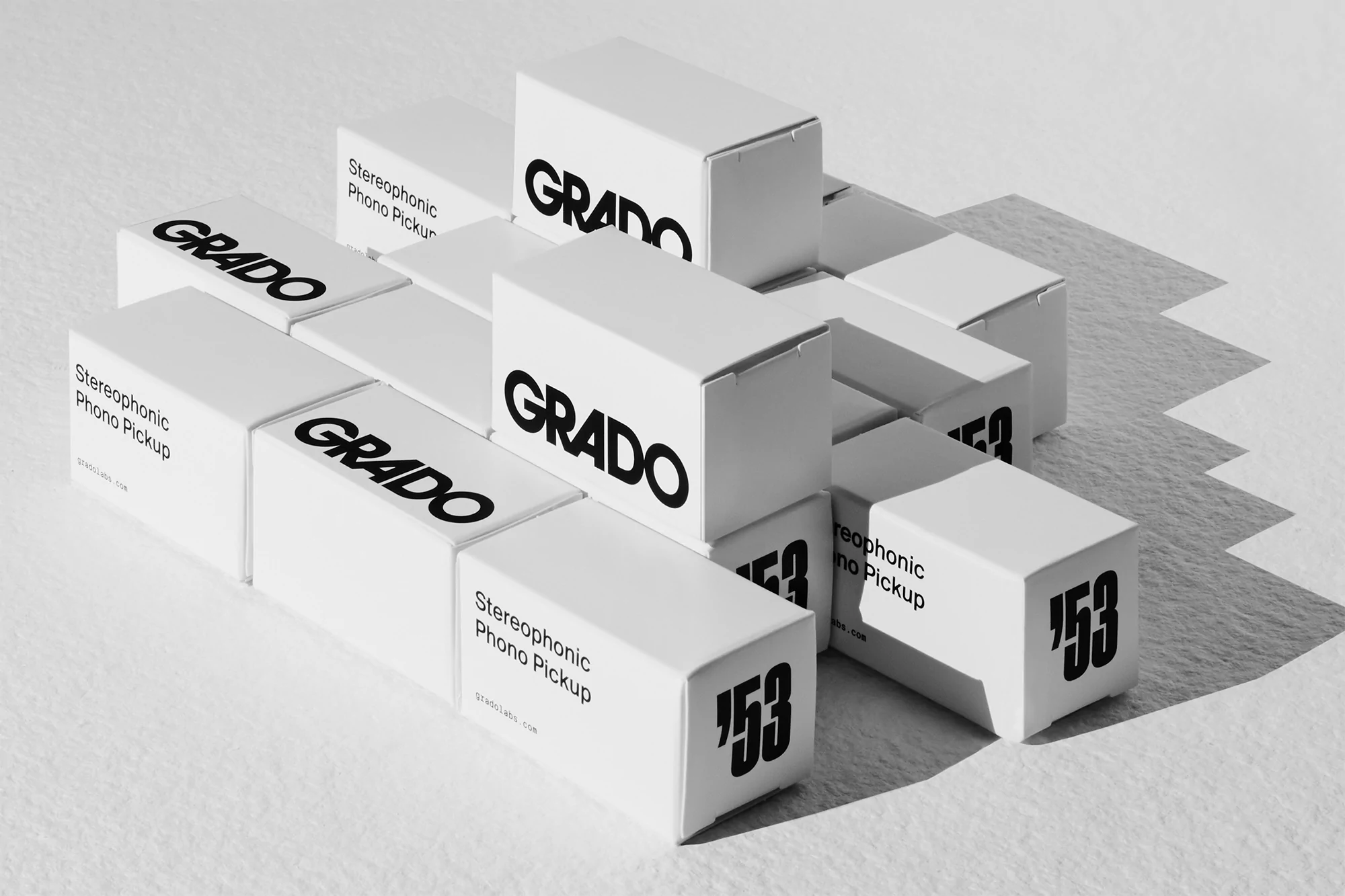 Grado stereophonic phono pickup boxes arranged and stacked in a product display, with bold typography in black and white.