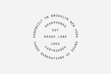 Circular typographic brand logo for Grado Labs on a plain white background featuring text about Brooklyn headphones and 1953 cartridges.