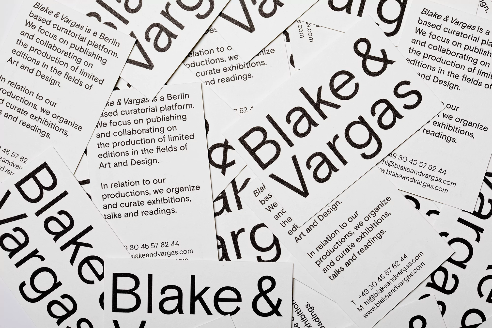 Close-up of scattered business cards featuring the company name 'Blake & Vargas' in bold, against a clean white background.
