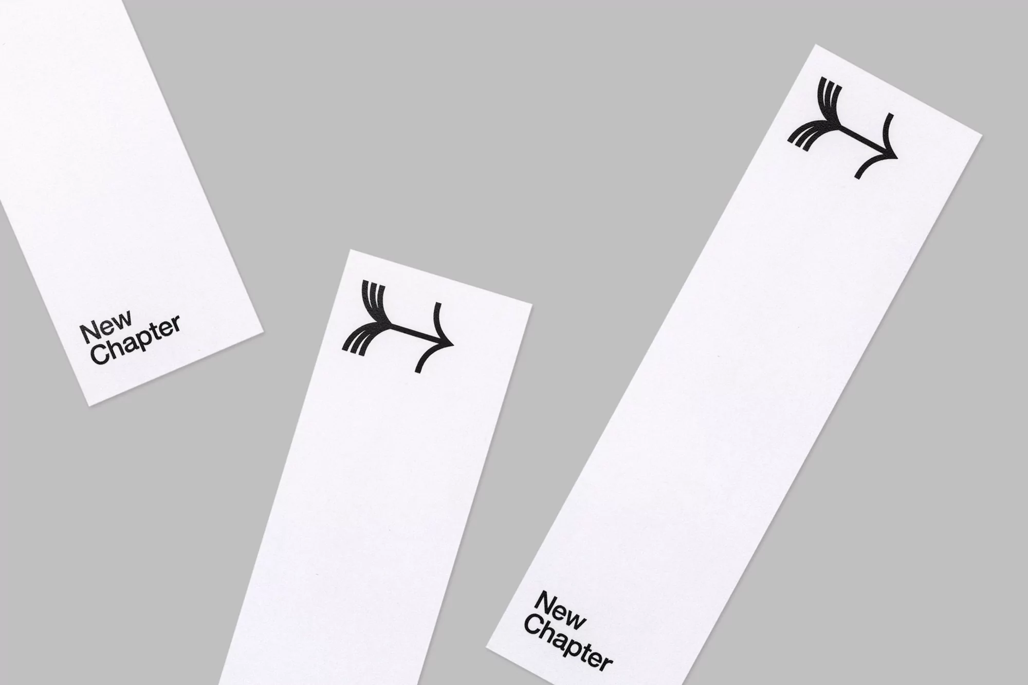 Three white rectangular cards are displayed against a grey background. Each card features a black arrow icon; two have 'New Chapter' text.