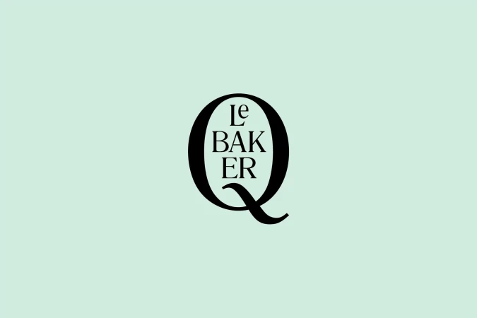 Elegant logo featuring a stylized letter Q with the words 'Le Baker' incorporated, set against a soft, light-green background.