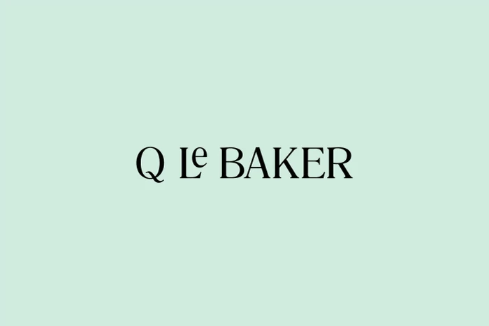Q Le Baker brand identity logo featuring black serif typography centered on a solid pastel mint green background.