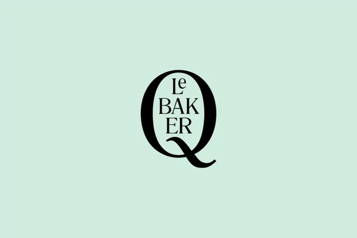 Black custom typographic logo for Q Le Baker centered on a solid light mint green background.