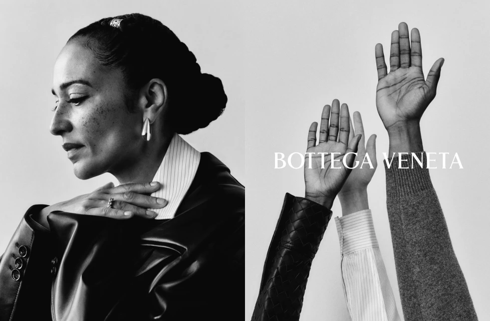 Black and white fashion shot of a woman in a blazer and three raised hands wearing various sleeves with Bottega Veneta text overlayed.