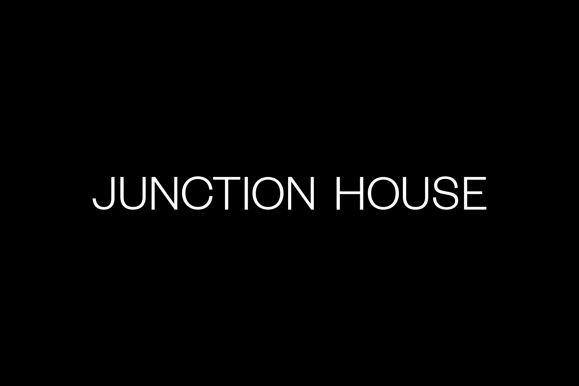 Text 'JUNCTION HOUSE' in white on a black background, simple presentation, bold typography, high contrast.