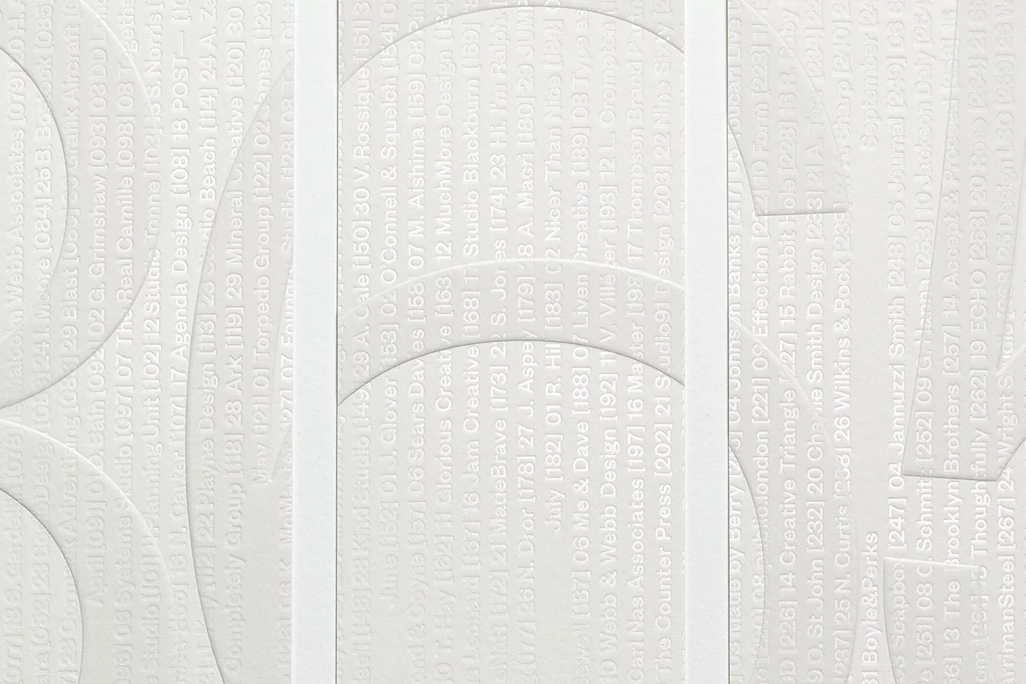 Monochrome embossed paper design featuring curved architectural shapes and layered typographic details by Fedrigoni
