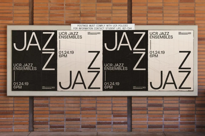 Black and white Jazz Ensemble posters are attached to an exterior brick wall, promoting an event on January 24, 2019, at 6 PM.
