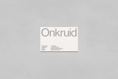 A white rectangular business card for Onkruid centered on a textured grey background surface.