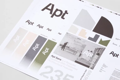 Printed brand identity guidelines sheet showcasing logo typography colour swatches and architectural imagery for Apt.