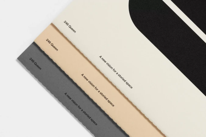 Minimalist presentation of paper samples in grey, beige, and cream with modern typography, showcasing texture and color variations.