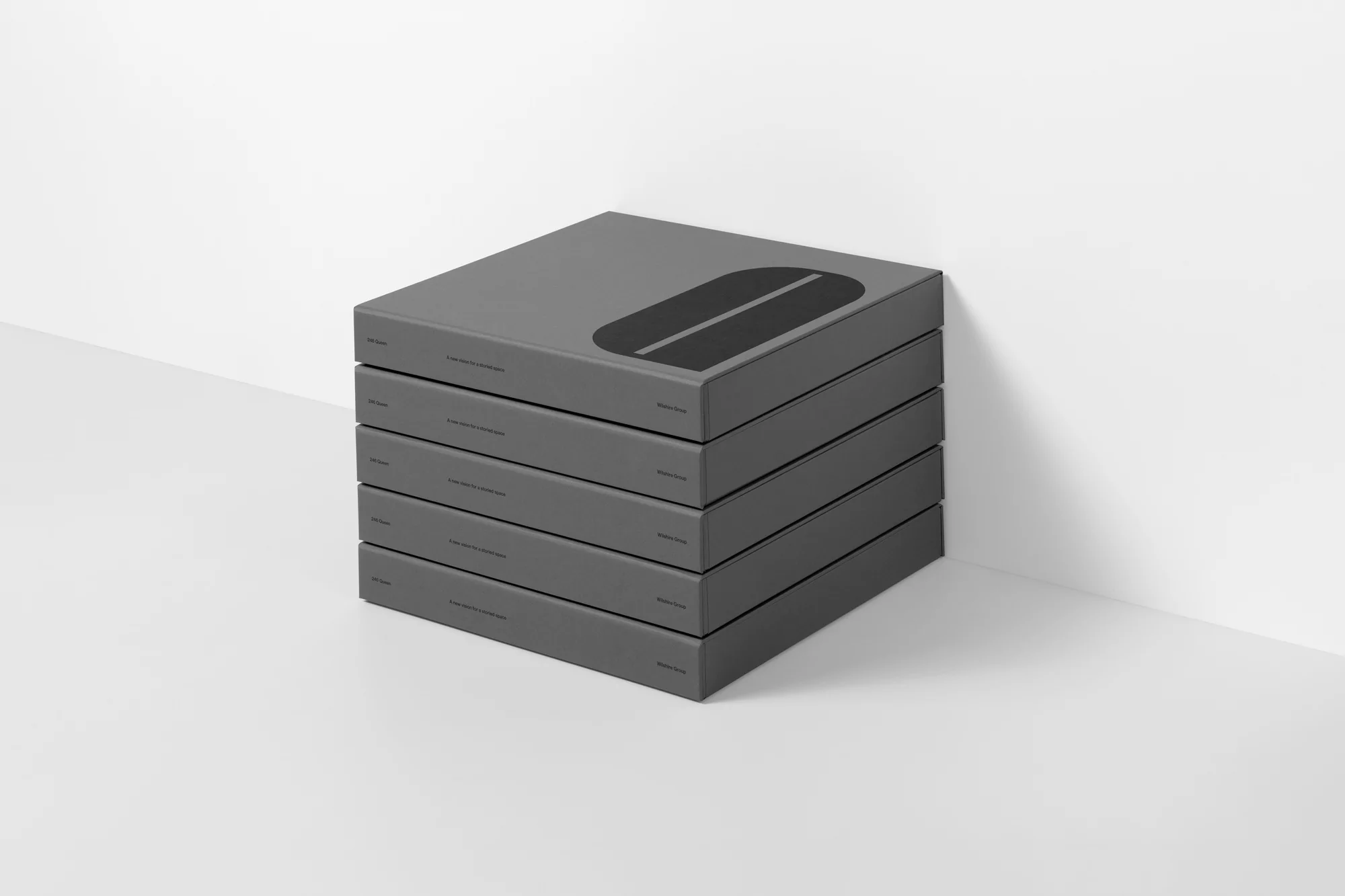 Stack of five grey books with a black oval design and white text, positioned against a white background with subtle shadows.