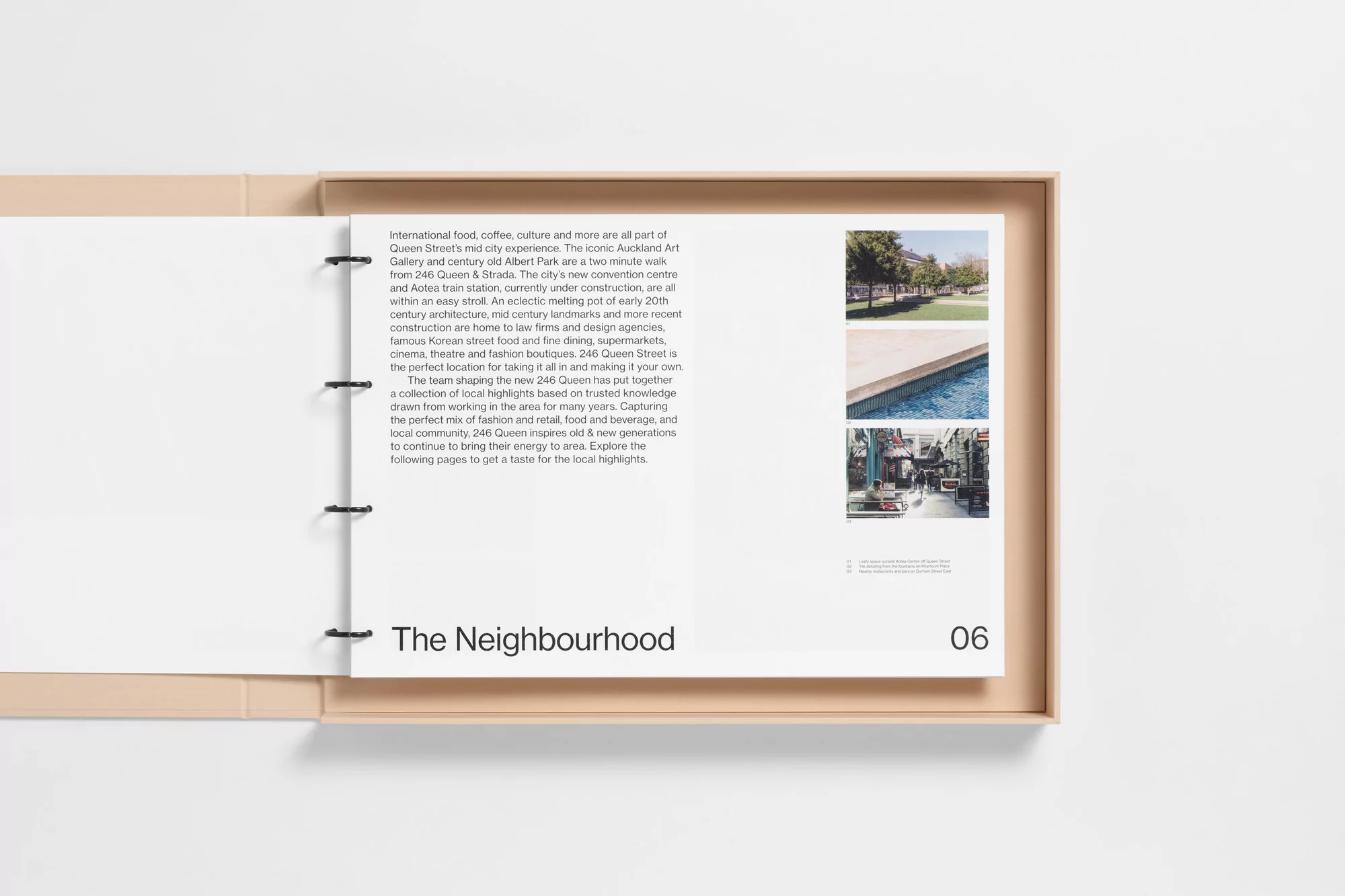 Open architectural brochure featuring photography of a neighborhood with a description of Queen Street in Auckland, New Zealand.