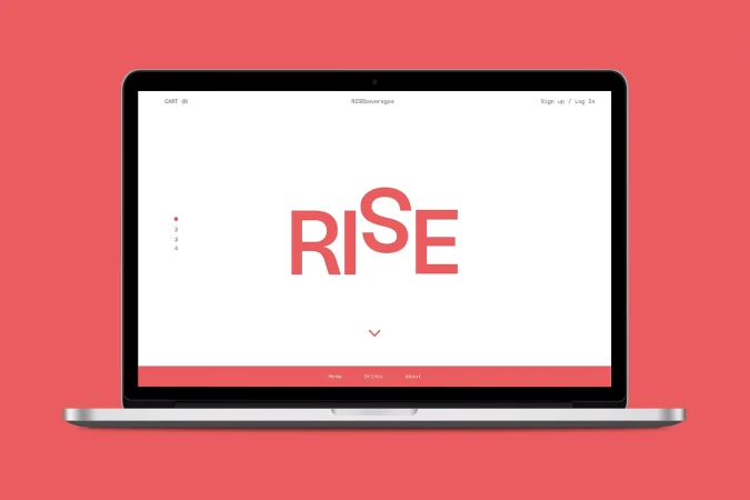 Laptop computer displaying a website with the word 'RISE' in coral-red text on a white screen, set against a coral-red background.