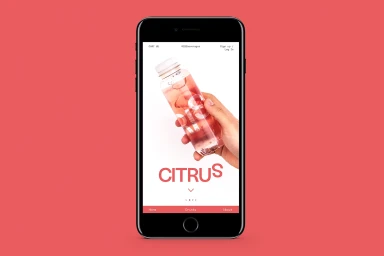A smartphone mockup displaying a mobile app interface featuring a hand holding a bottled beverage against a coral red background