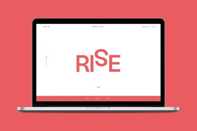 A laptop displaying the Rise brand website on a red background.