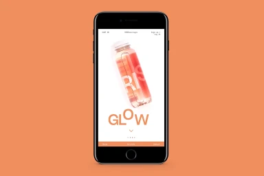 Black smartphone mockup displaying a beverage brand web interface on a solid orange background