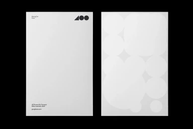 Two white stationery cards featuring minimalist typography, a geometric logo, and subtle circular blind embossments on the reverse.