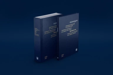 Two dark blue books with white typography titled Arjowiggins International standards for creative papers on a dark blue background.