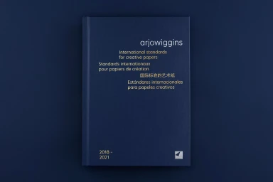 Dark blue hardcover book with gold foil typography centered against a dark blue background surface.