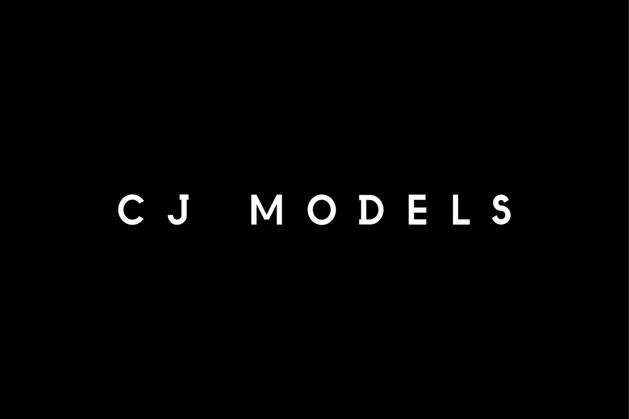 Minimalist image featuring the text 'CJ MODELS' centered on a black background in a clean, sans-serif typeface. Agency branding.