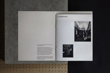 Open brochure layout displaying text and two architectural photographs on a concrete background.