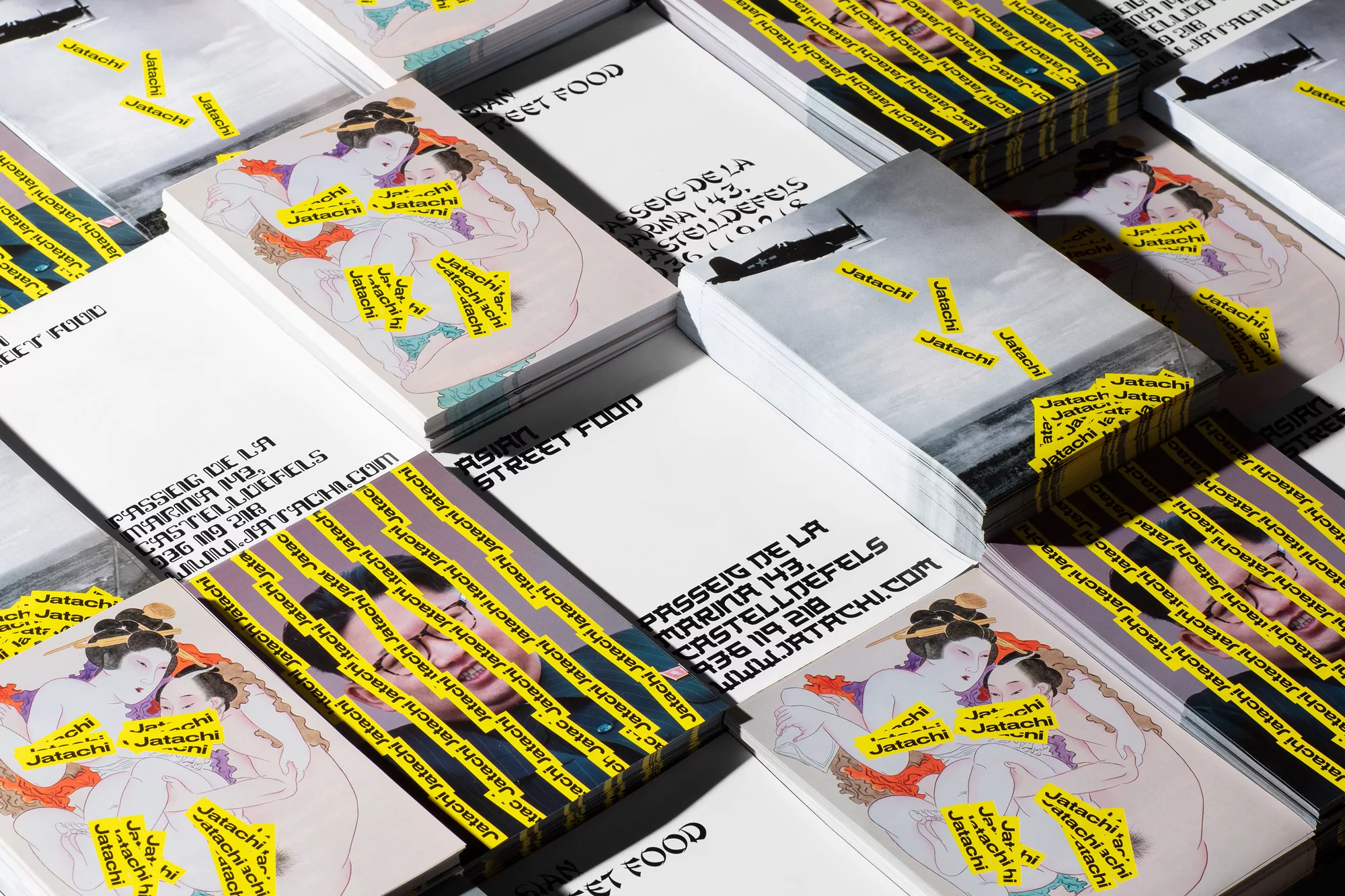 Stacks of business cards with stylized artwork and Japanese street food text, arranged in an overlapping grid, show business promotion.