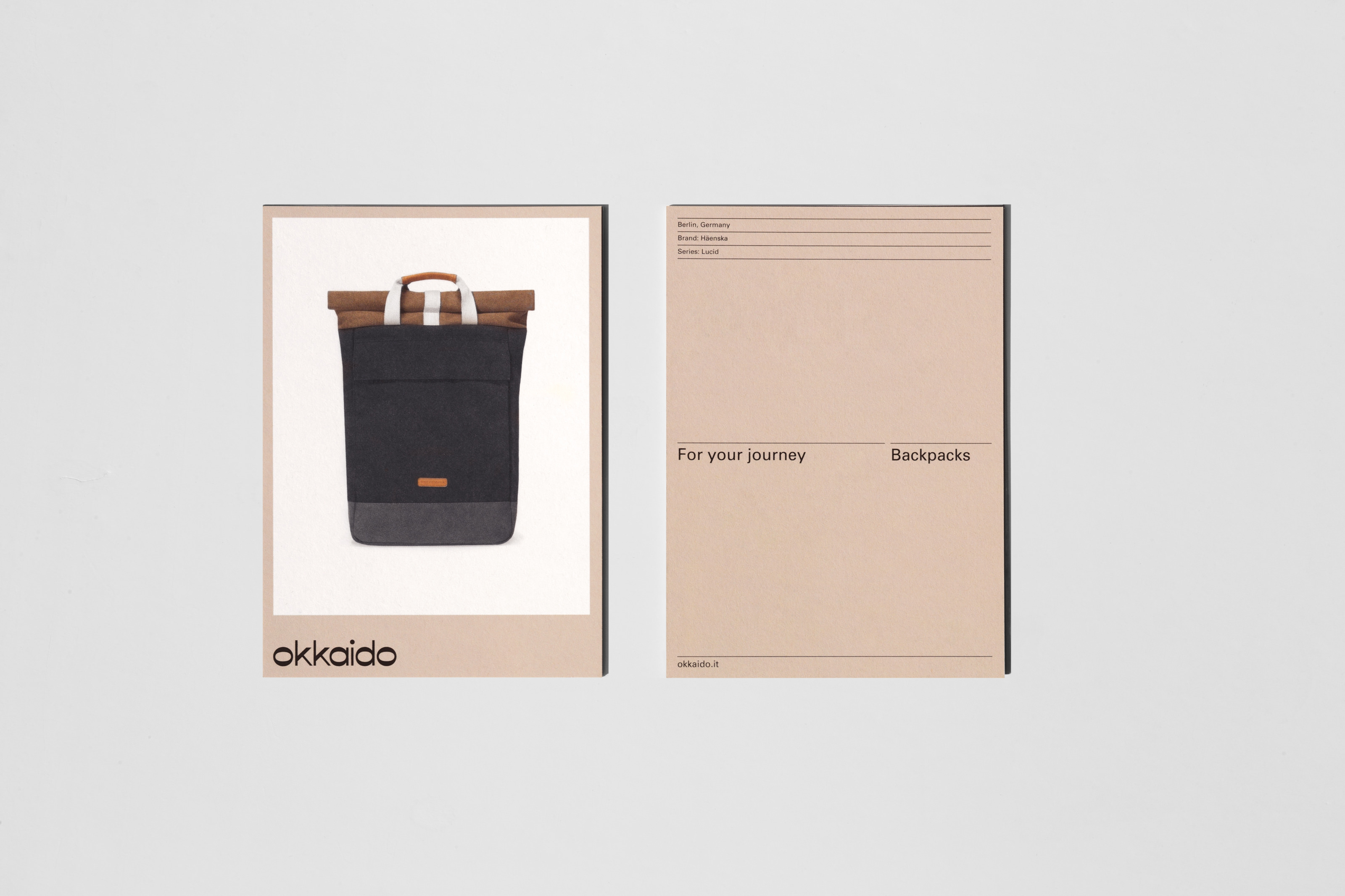 Promotional postcard for okkaido, showcasing a backpack with a brown and black color scheme, next to descriptive product copy.