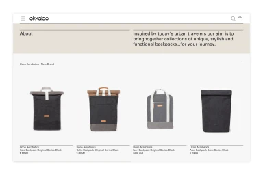A screenshot of the Okkaido e-commerce website featuring a grid of four black backpacks against a clean white background.
