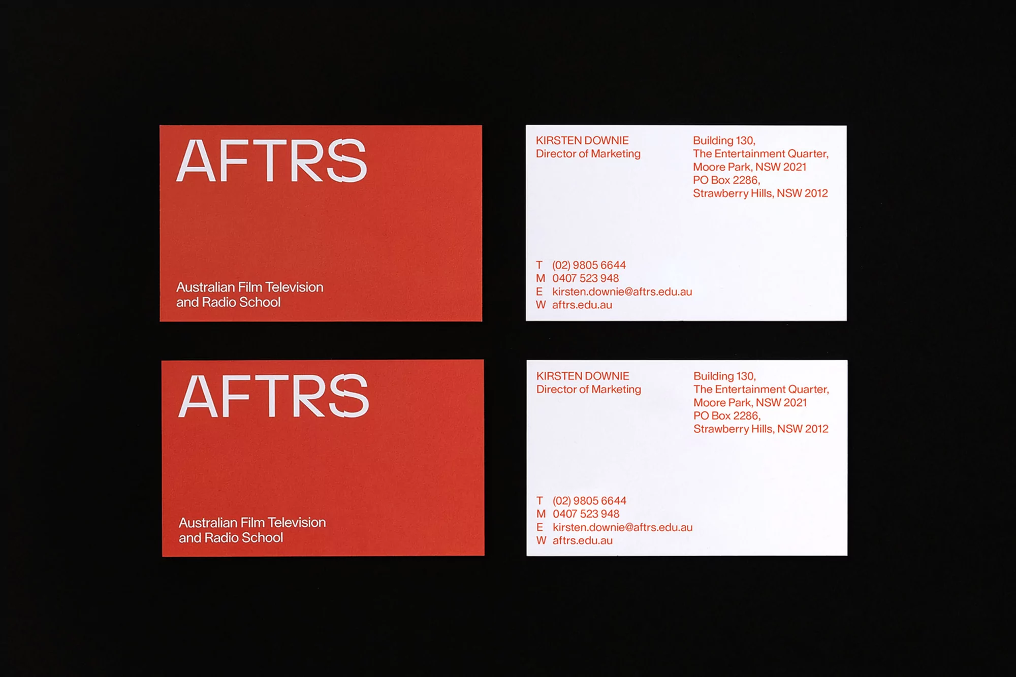 Two sets of business cards for AFTRS (Australian Film Television and Radio School) are arranged on a dark background.