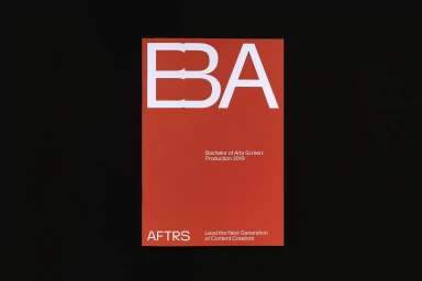 Red rectangular graphic print featuring large white bold letters spelling BBA against a black background