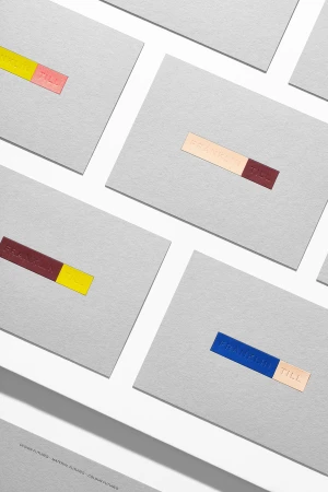 Minimalist stationery featuring horizontal color blocks and embossed text on gray paper. Modern, clean design for business or personal correspondence.